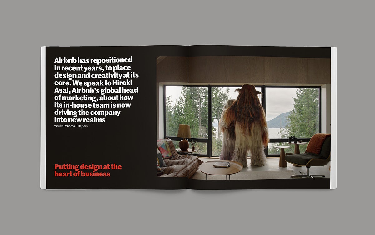 Image shows a spread from the Creative Review Creative Leaders 2023 issue, showing a block of white text on a black background and the headline 'Putting design at the heart of the business' on the left hand page, and on the right hand page is a full-bleed image of a large furry character looking out of a window over a lake