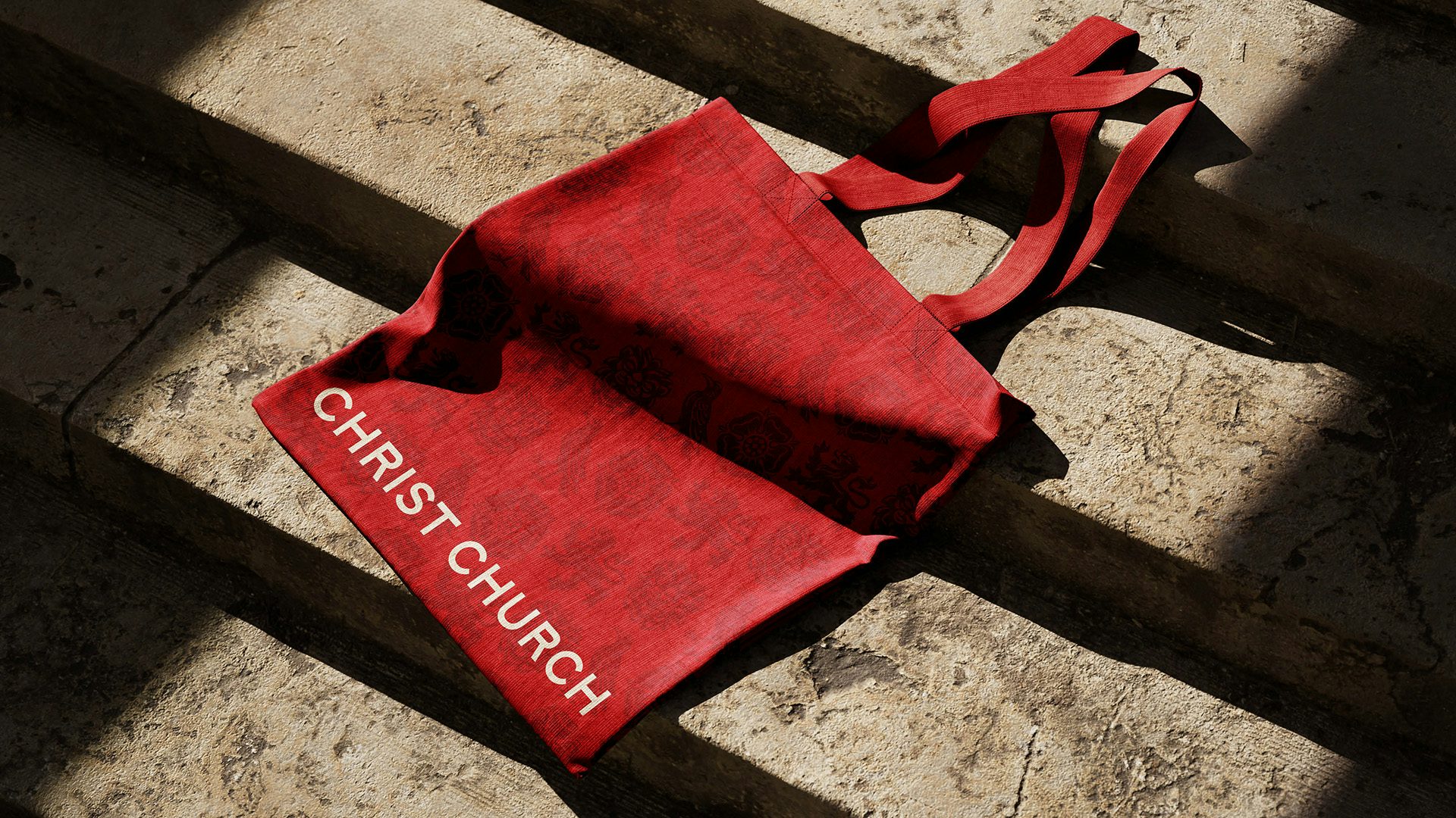 Photo showing Christ Church Oxford's branding on a red tote bag