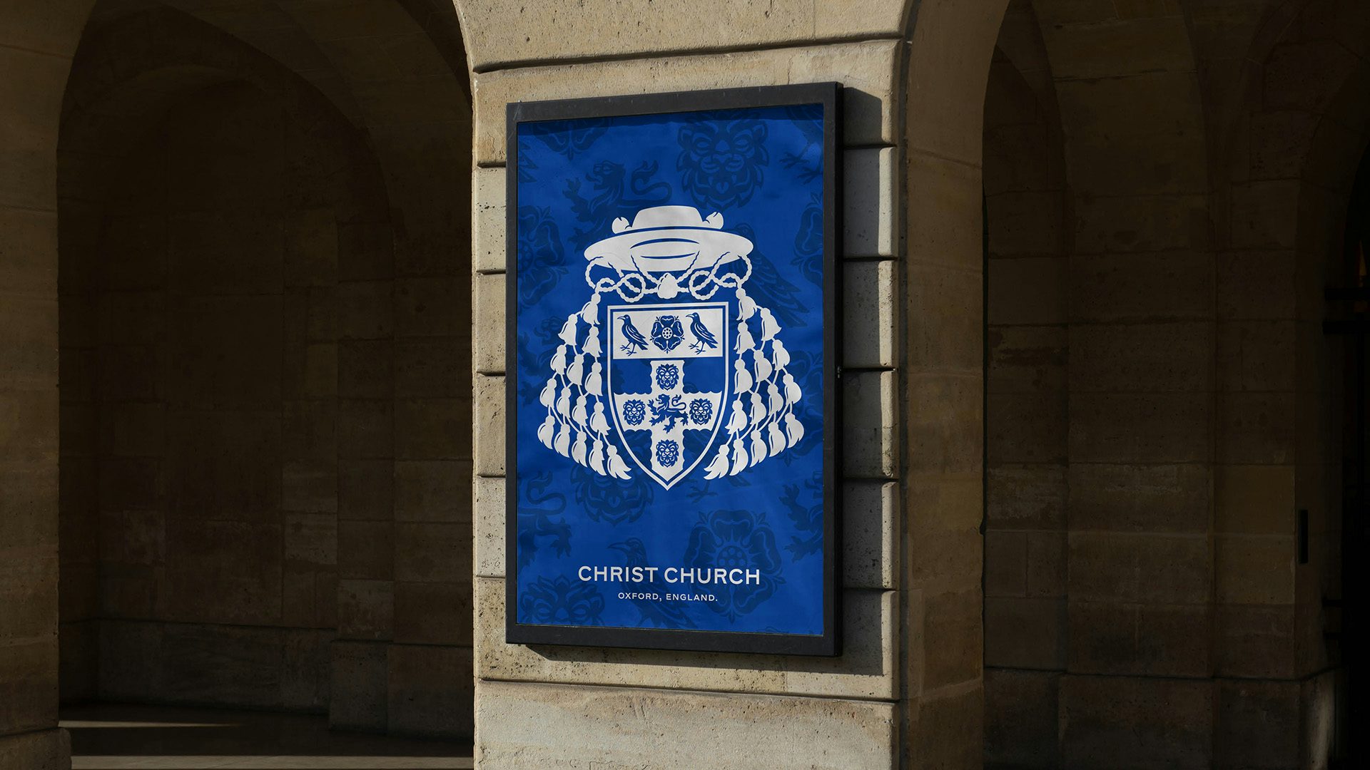 Photo of an example of Christ Church Oxford's branding featuring a crest based on a shield, tassels, and a hat