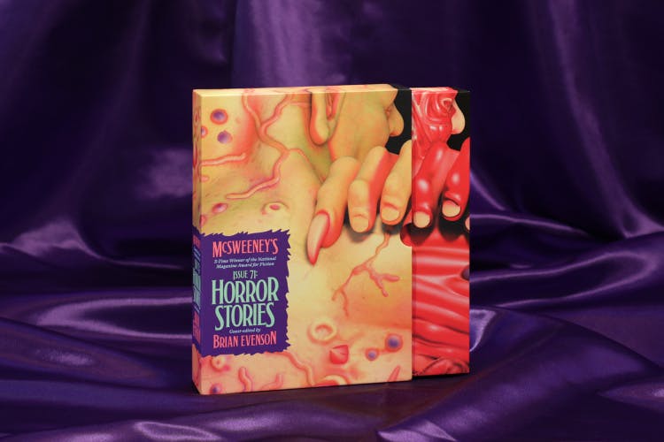 Photo showing the outer case for McSweeney's Issue 71 Horror featuring a horror illustration featuring pale flesh and finger nails, shown against a purple silk fabric backdrop