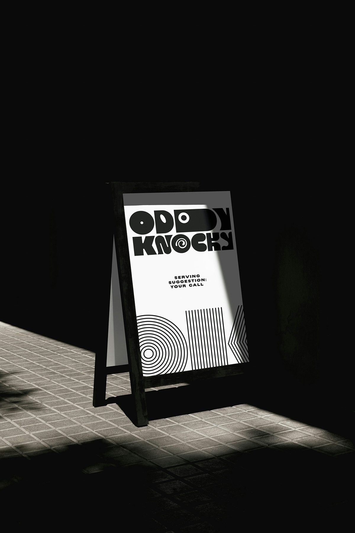 Photo showing the branding for Oddy Knocky on a sandwich board, featuring the letters 'O' and 'K' in black multiline type and the quirky logotype