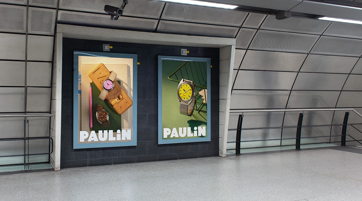 Image shows Paulin advertisements on vertical displays in a station, showing the brand's uppercase wordmark against lifestyle photography of its watches