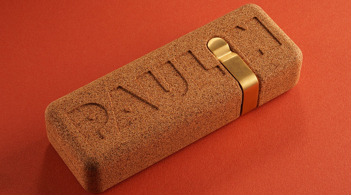Image shows the cork packaging designed for Paulin, shown against a orange-red background