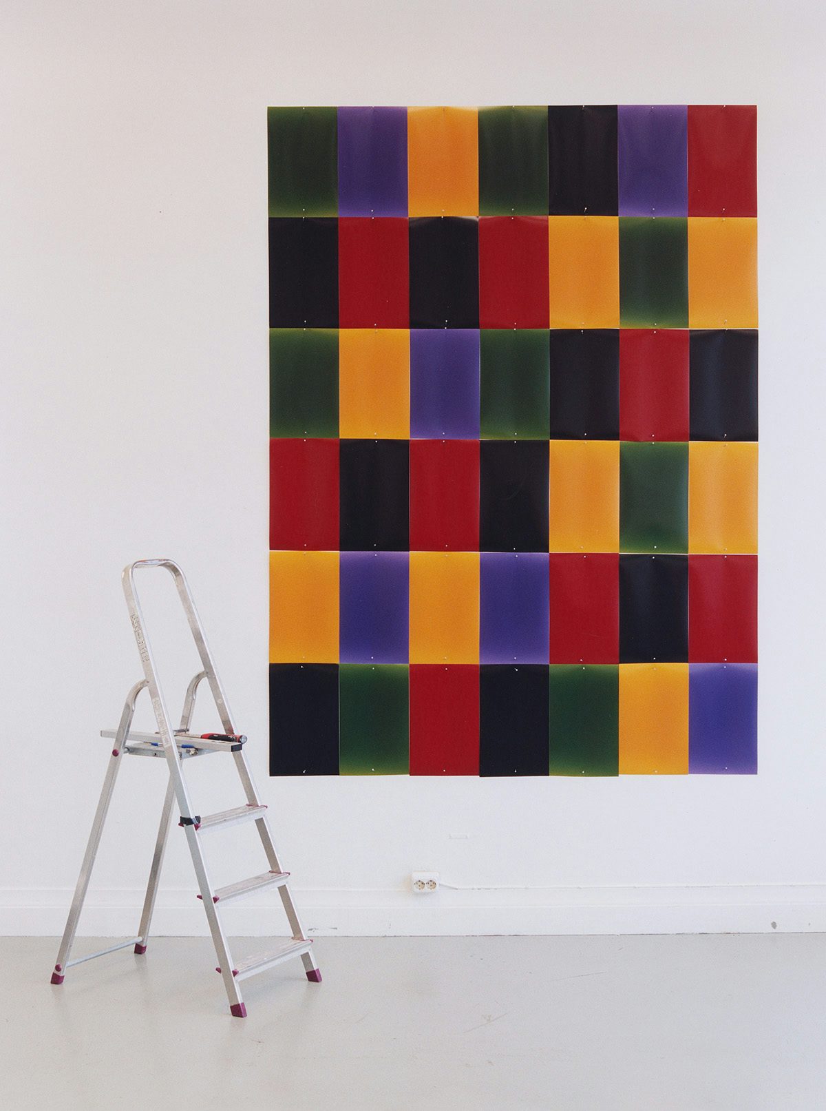 Image of a step ladder next to a tiled wall hanging by Erik Gustafsson