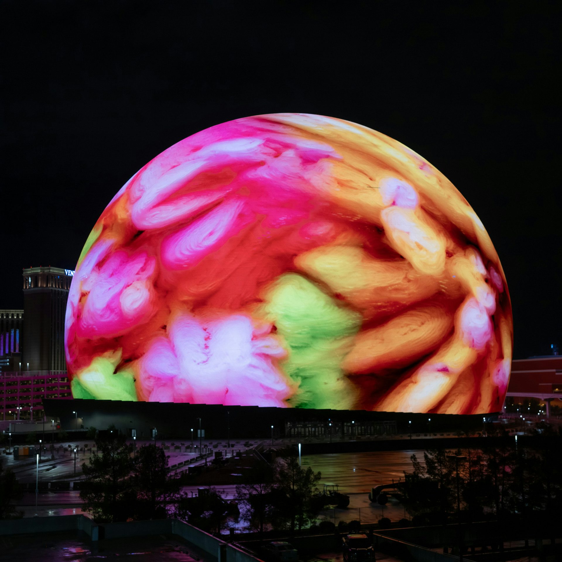 Image of the exterior of the Sphere in Las Vegas showing a colourful AI visualisation by Refik Anadol