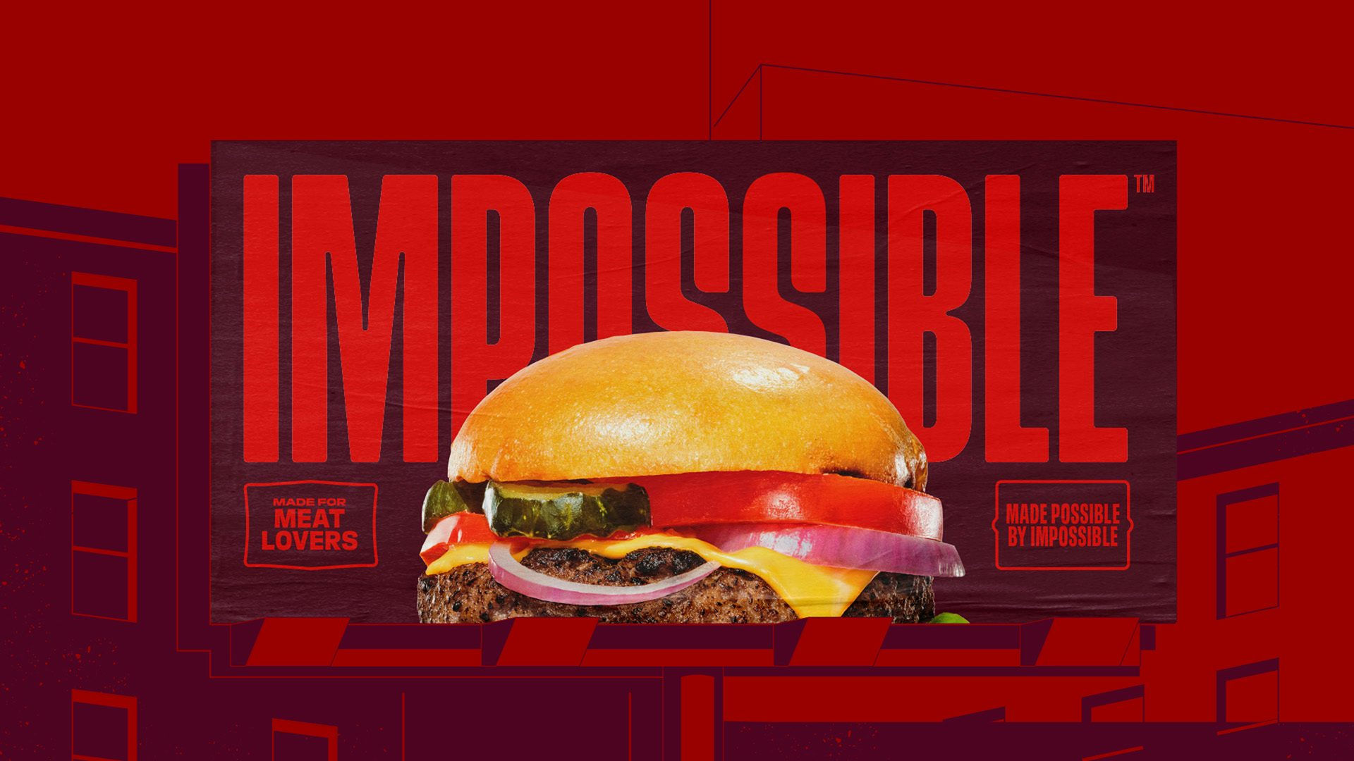 L'image montre la nouvelle marque Impossible sur une affiche horizontale avec une photo d'un hamburger devant le lettrage