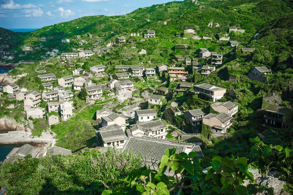 Photo from Project Urbex by Ikumi Nakamura showing a village set into a green hillside