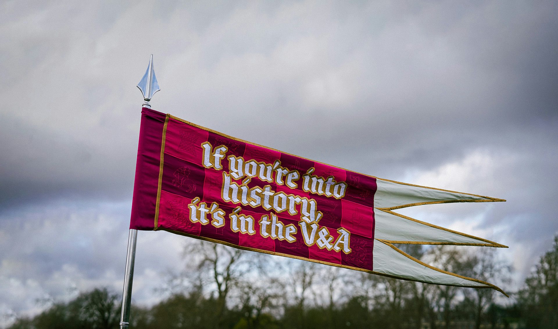 Image showing the V&A campaign slogan 'if you're into it, it's in the V&A' written on a red medieval flag