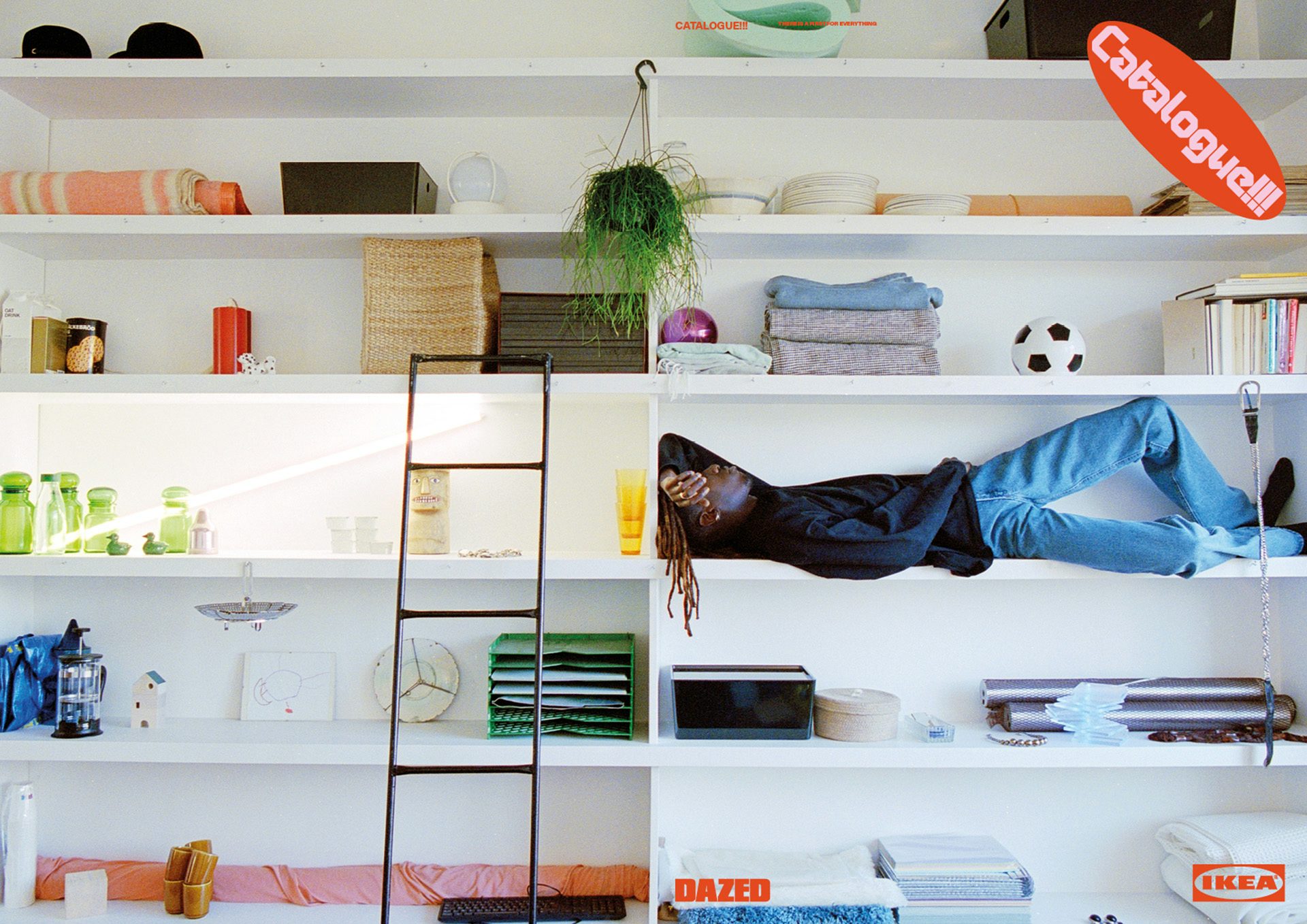 Photograph from Dazed and Ikea's zine showing a person lying on a shelf within a shelving unit inset into a wall