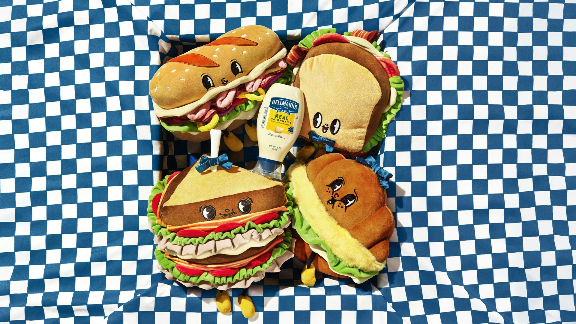 Plushie toys in the shape of sandwiches with a cartoonish smiling face