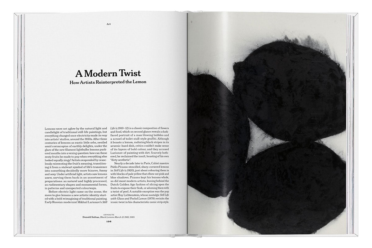 Photograph of a spread from The Gourmand's book, Lemon, with a written text headlined 'A modern twist' on the left hand page, and on the opposite page is an artwork featuring three black fuzzy silhouettes of lemons on a pale background