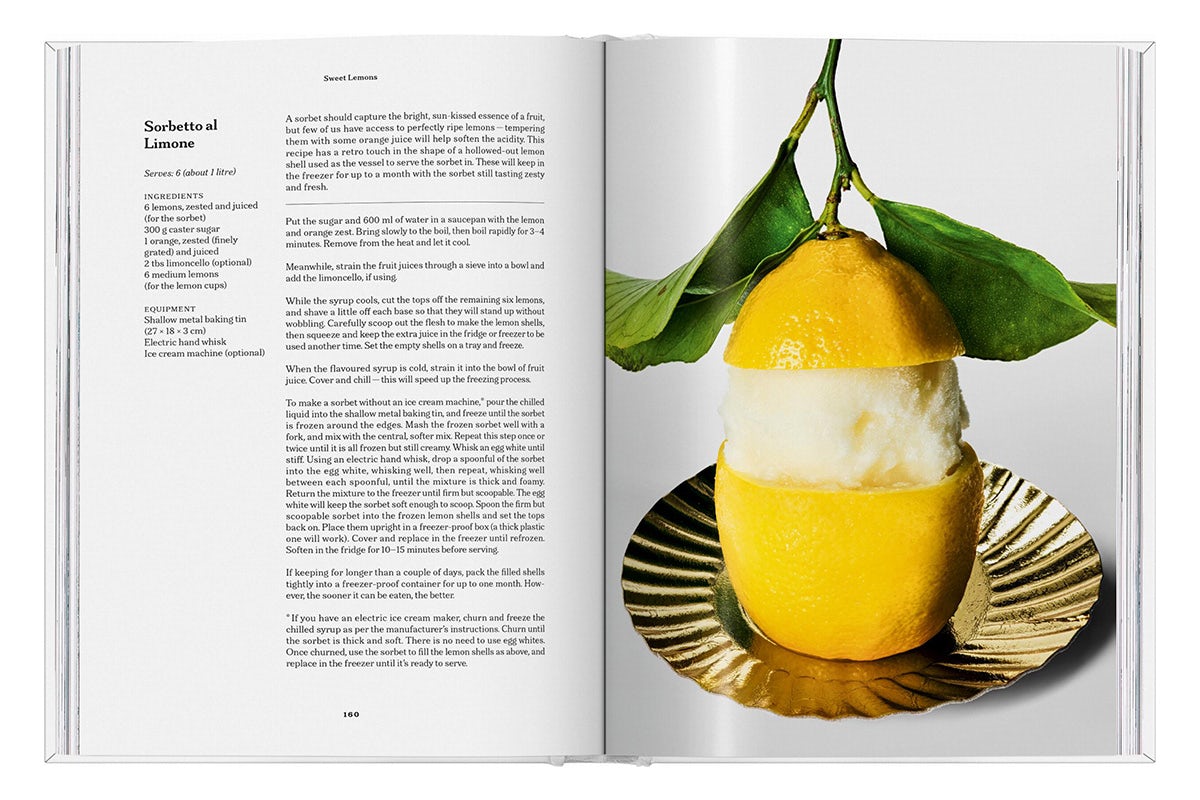 Photograph of a spread from The Gourmand's book, Lemon, featuring a recipe page on the left and a photograph of a lemon where a ring of peel has been removed from the middle, placed on a golden dish