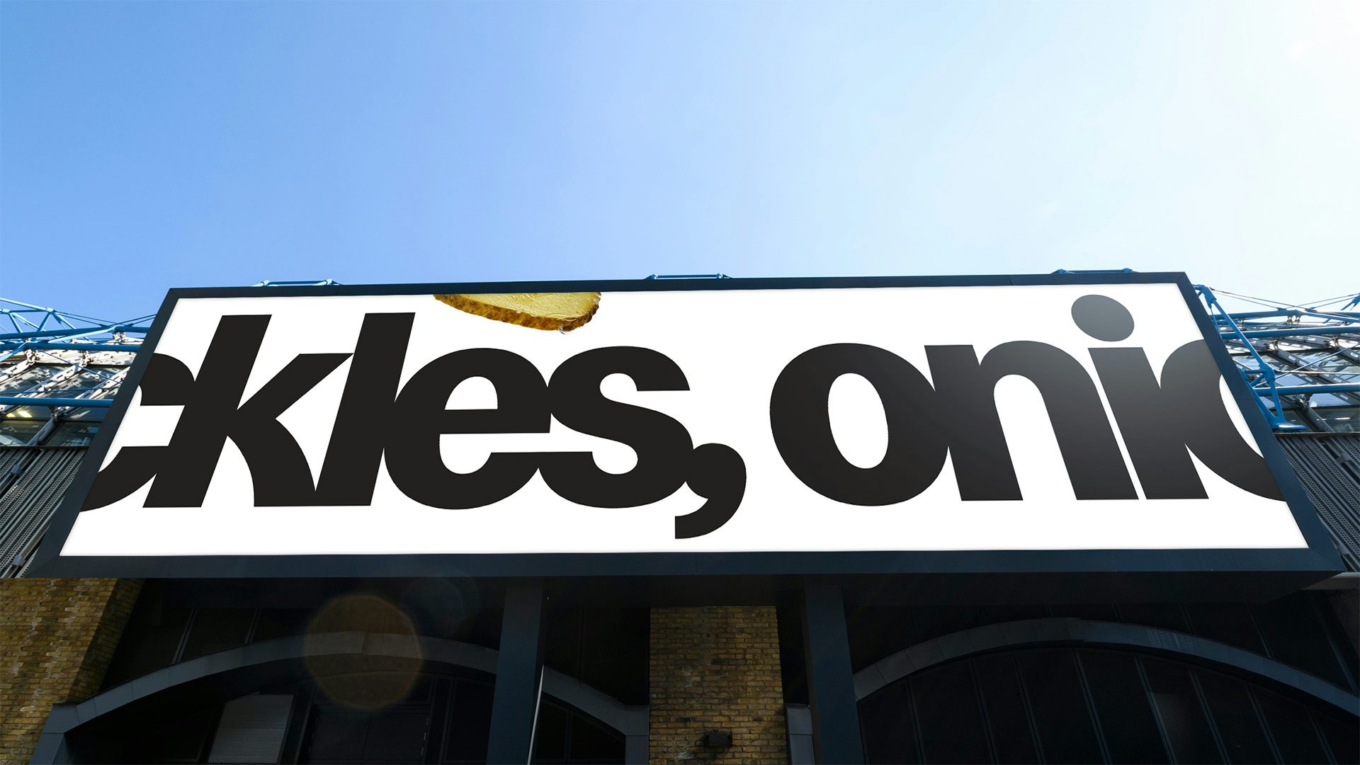 Billboard featuring a deliberately cut-off line that reads 'ckles, onio'