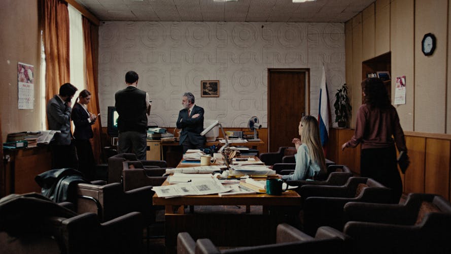 Reporters Without Borders campaign film still, showing a group of journalists in a busy office