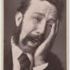 Sepia toned photo of a person with a moustache and wearing a suit and tie, apparently in tears clutching their jaw in pain