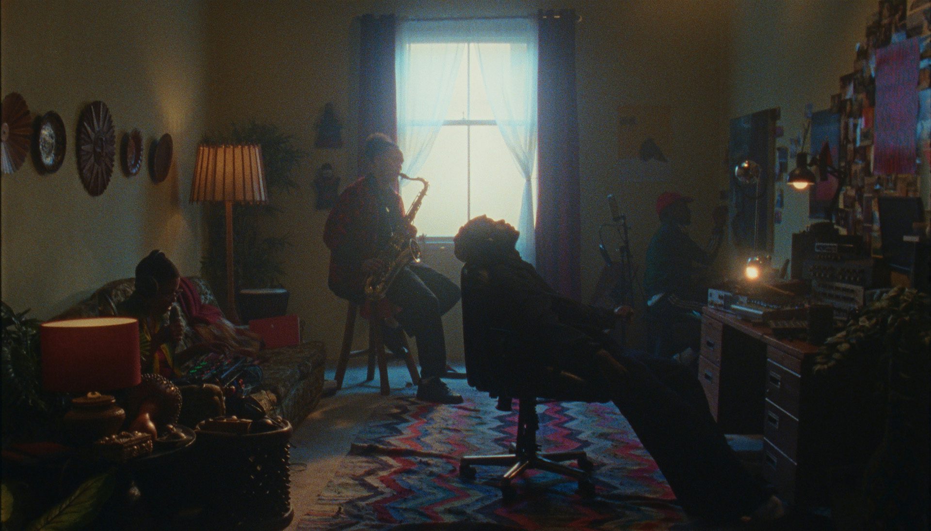 People sat in a living space with instruments