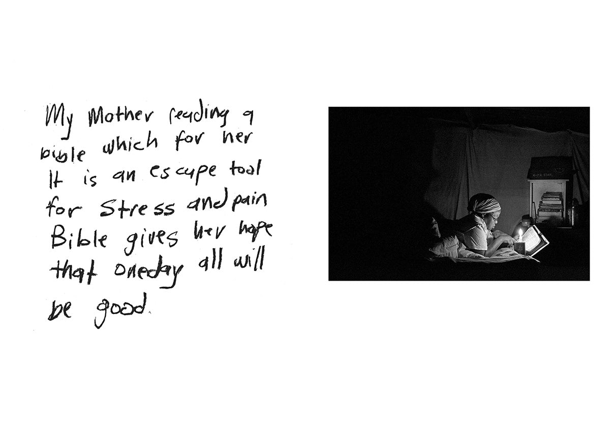 Black and white photo of a person reading by a small light. Next to the photo is a handwritten caption that reads 'My mother reading a bible which for her is an escape tool for stress and pain Bible gives her hope that one day all will be good'