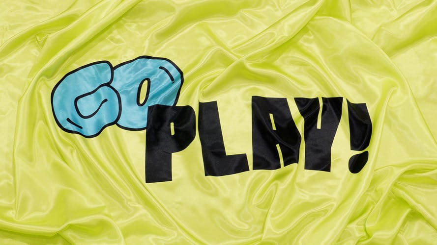 A yellow flag featuring the words 'Go Play!' in block lettering