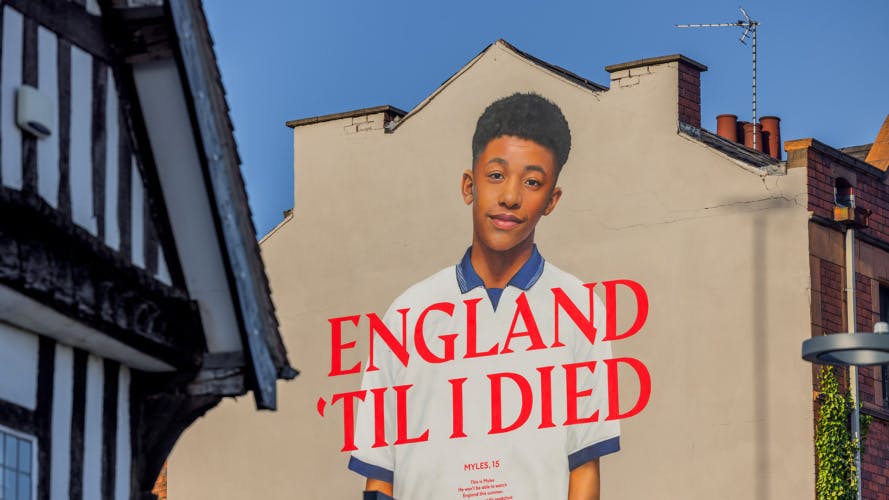 Mural on the side of a building featuring a portrait of a young person with the slogan 'England til I died'