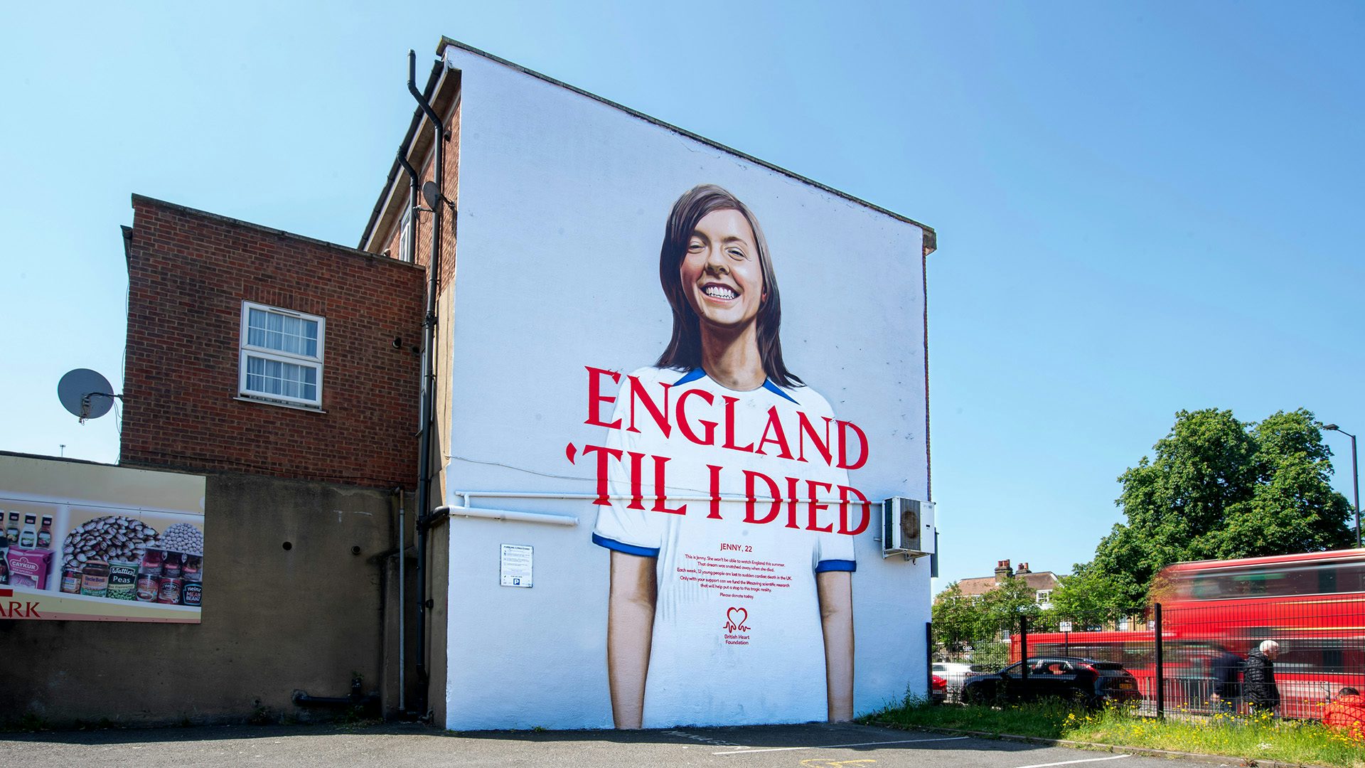 Mural on the side of a building featuring a portrait of a young person with the slogan 'England til I died'