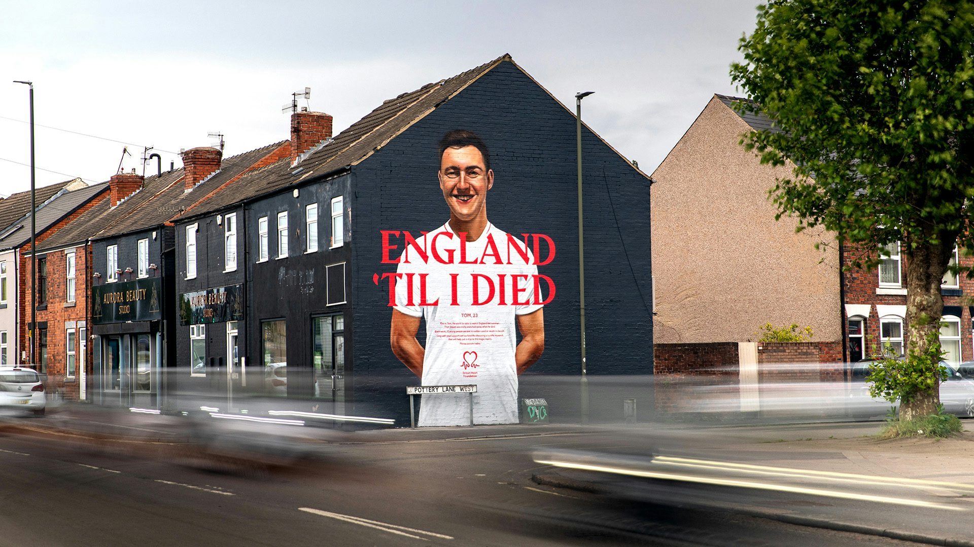 Mural on the side of a building featuring a portrait of a young person with the slogan 'England til I died'