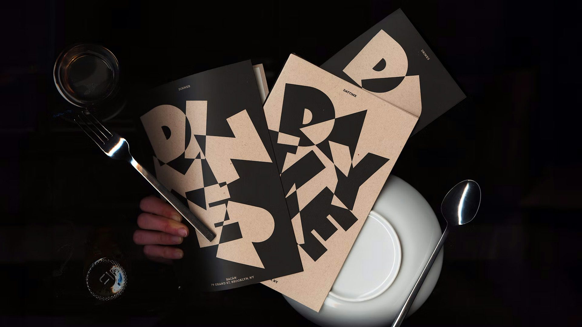 Menus featuring a futurist-inspired graphic made out of the word 'Bacan'