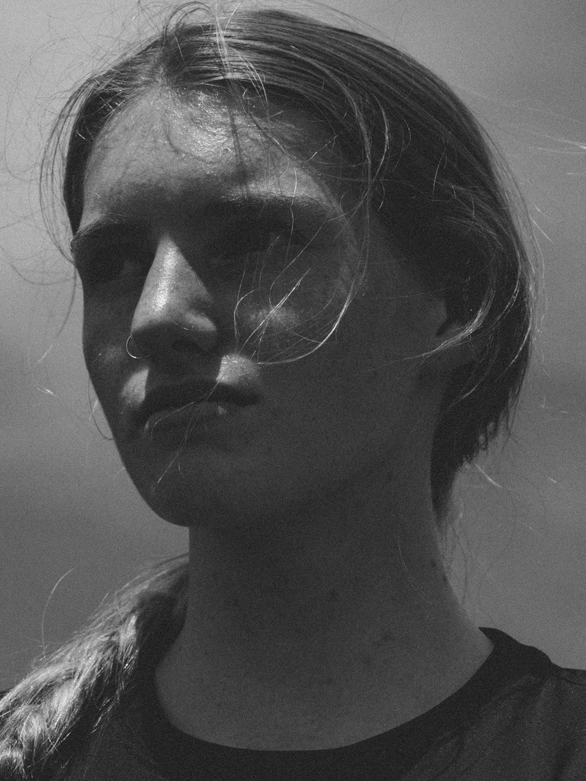 Black and white portrait photo by Robbie Lawrence of a young person with a plait and nose ring