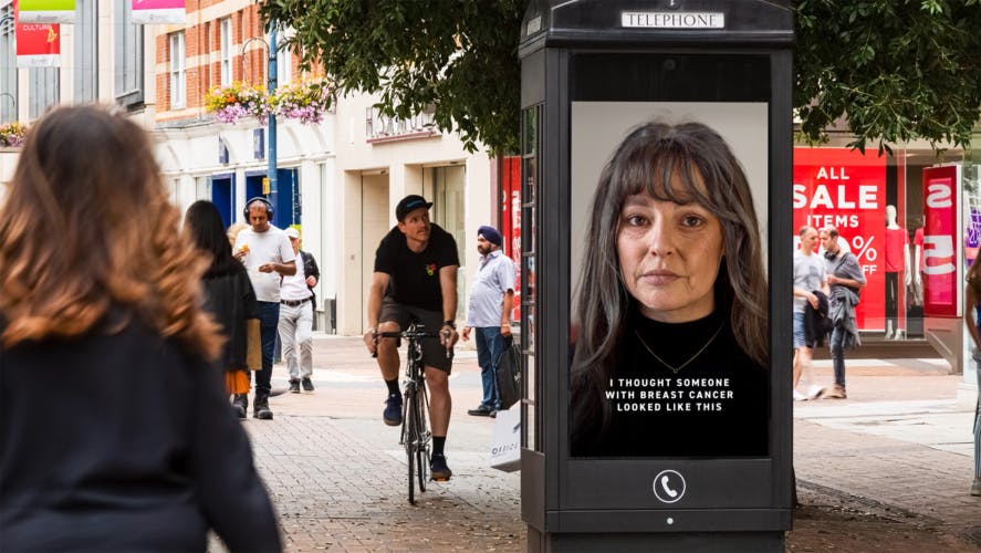 Outdoor advert for Coppafeel showing an older looking woman with the line 'I thought someone with breast cancer looked like this'
