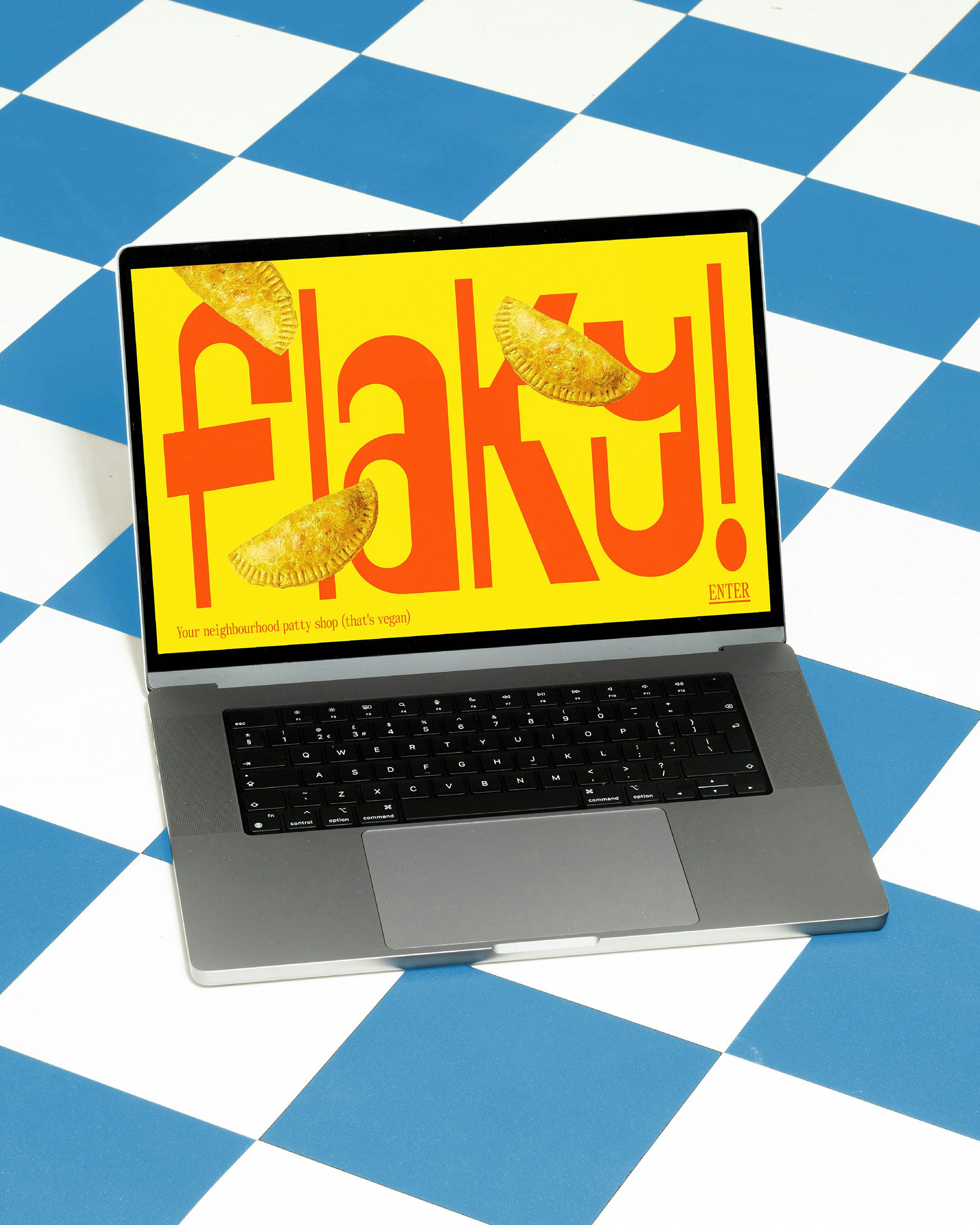 Laptop showing Flaky's orange angular wordmark with images of patties floating around it