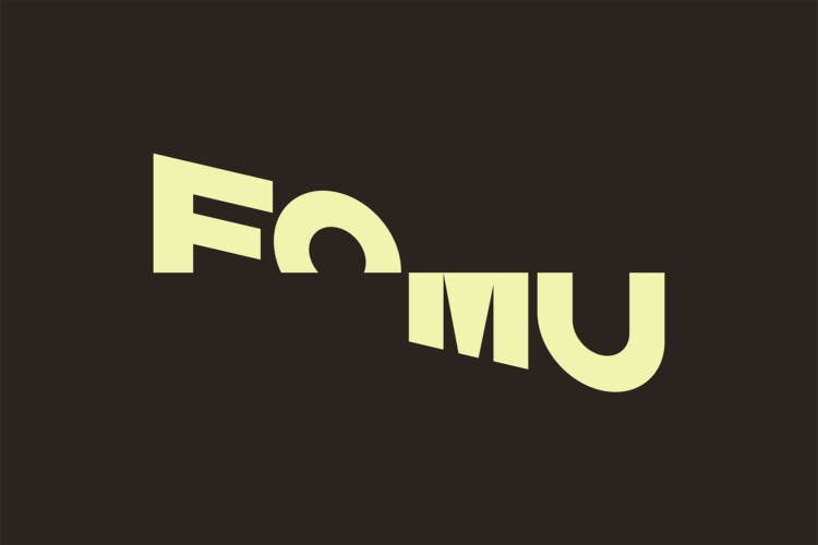 Fomu's diagonally sliced wordmark rendered in pale yellow against a very deep brown background