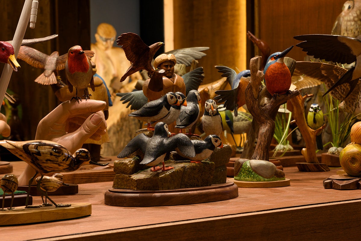 Exhibition installation of animals carved out of wood