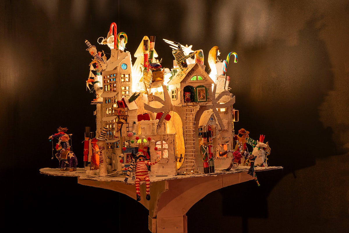 Exhibition installation of a whimsical house crafted out of wood