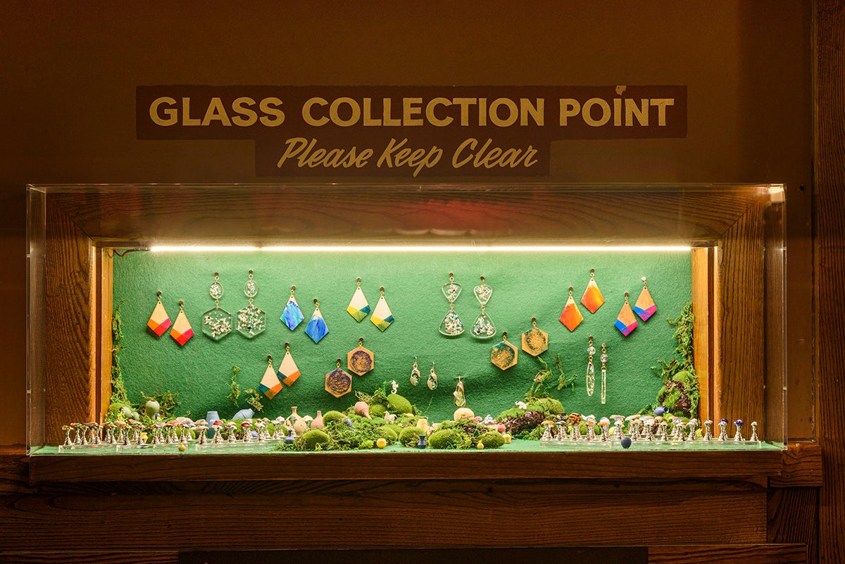 Exhibition display casefeaturing jewellery and figurines
