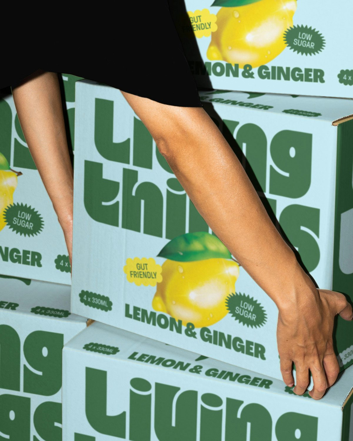 Boxes of Living Things soda in its green and blue packaging design