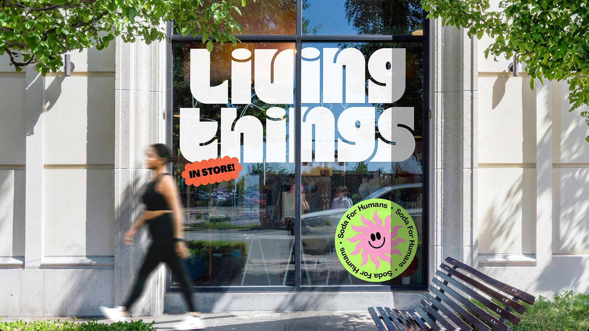 Living Things wordmark shown in thick white curvy letters on a glass office door