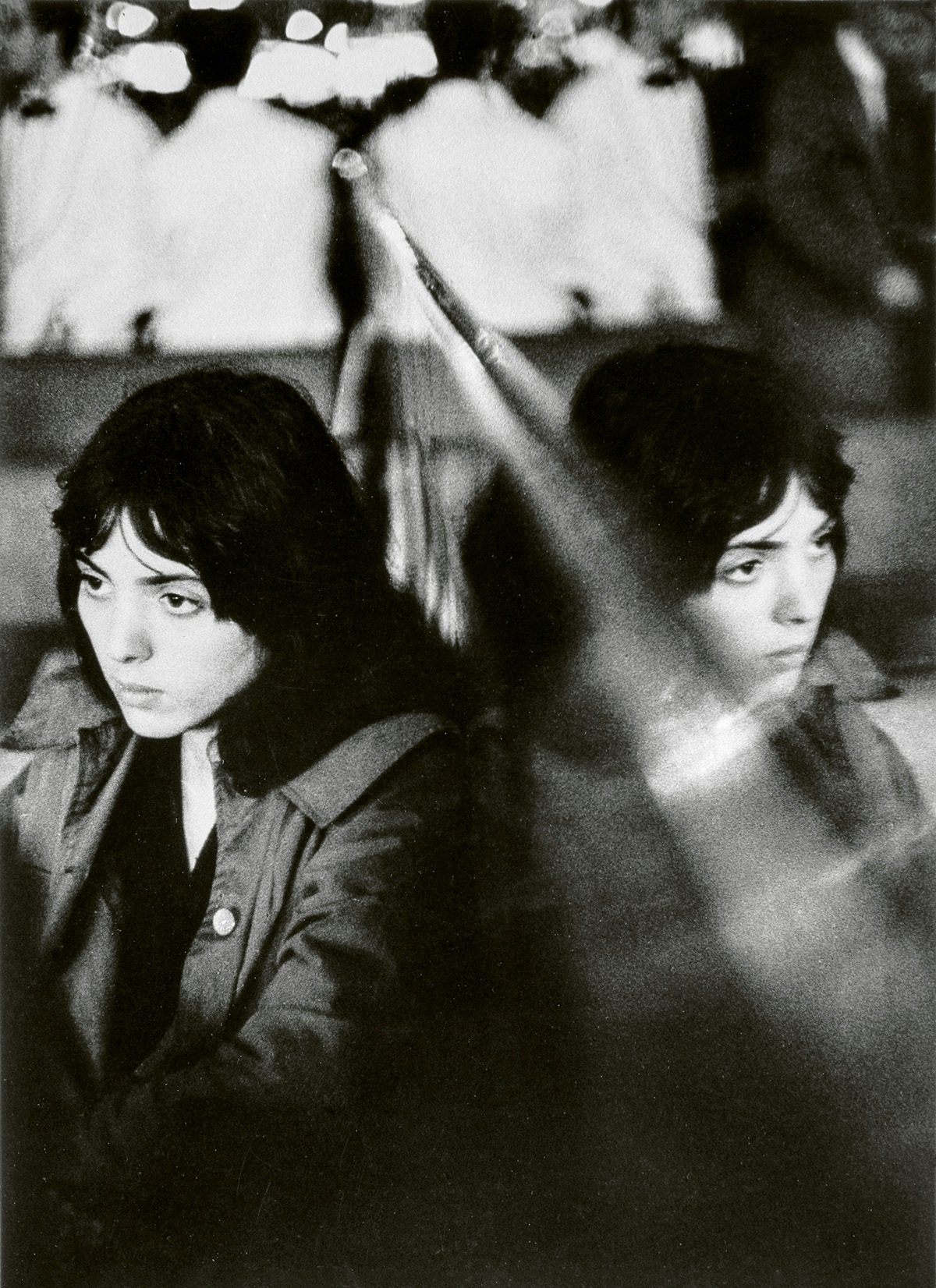 Black and white photo by Louis Stettner of a young woman and her reflection