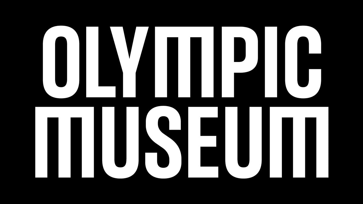 Olympic Museum wordmark laid out in white uppercase letters. The letter M features a flat top and sides
