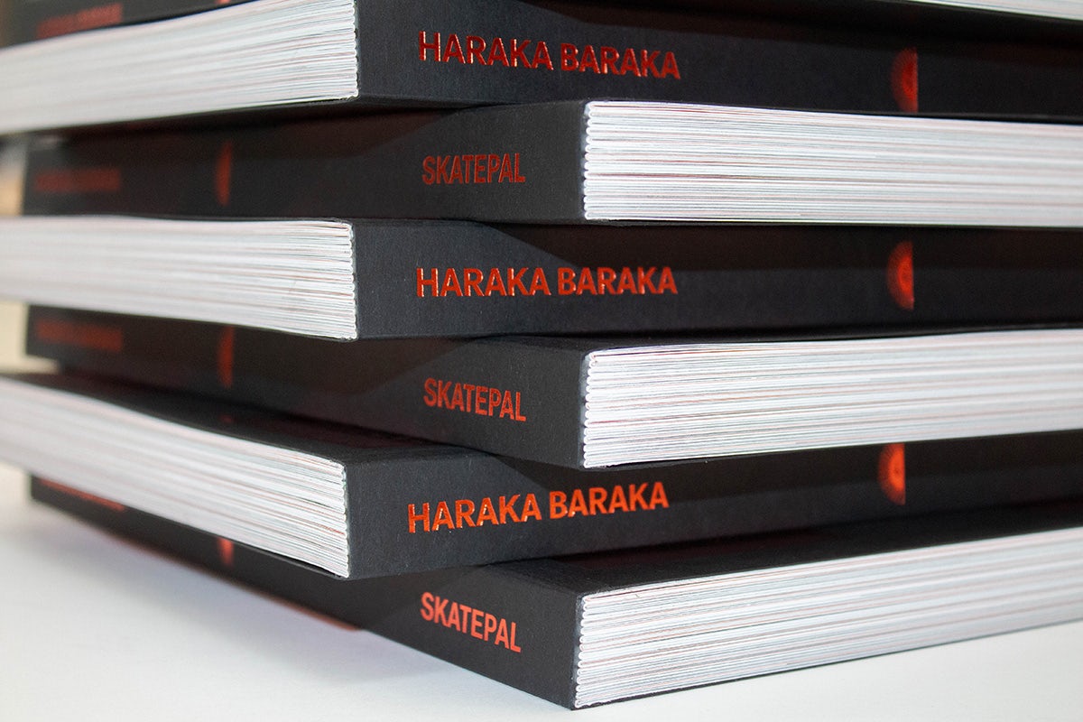 Book spines arranged in a stack, which read Haraka Baraka in red against a black spine