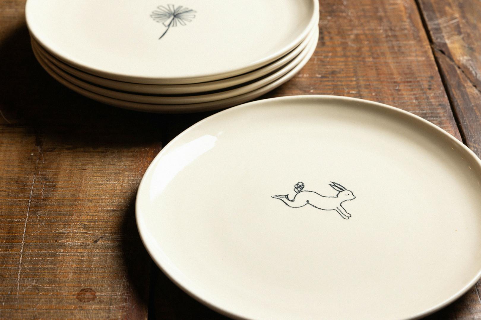 Pale plate with a rabbit illustration printed at the centre