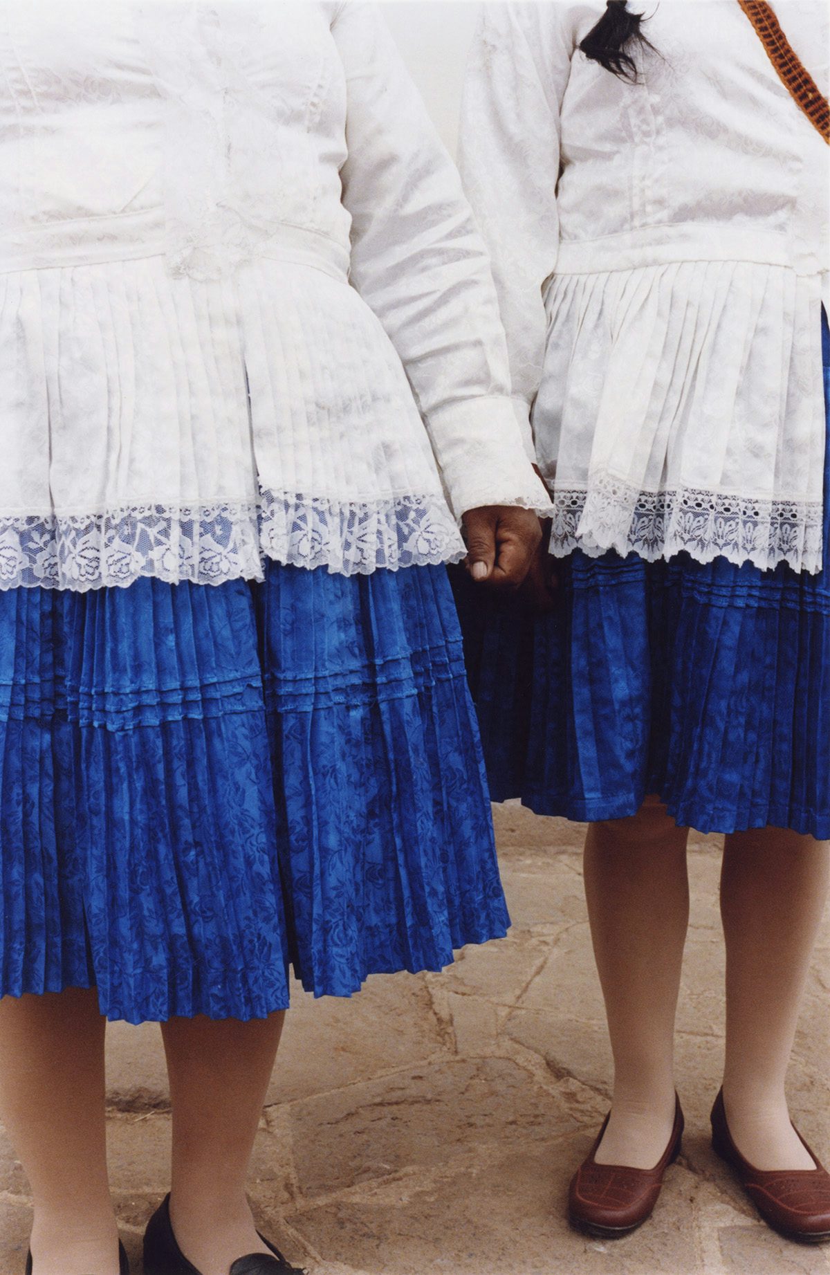 Photo by Ana Margarita Flores of two Peruvian women wearing blue and white clothing