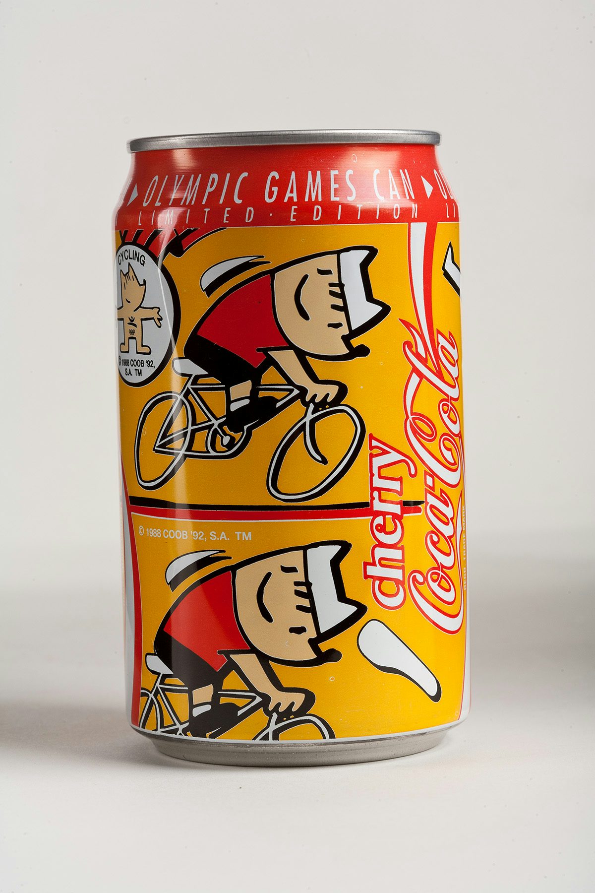 Can of Coca-Cola featuring illustrations of cyclists in an orange and red palette created for the 1992 Olympics