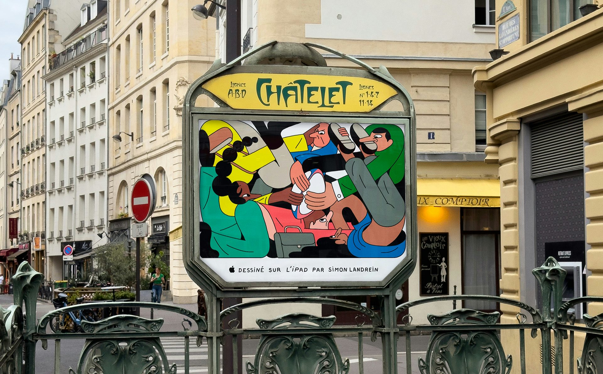 Illustrated poster by Simon Landrein shown in a display beneath a metro station sign