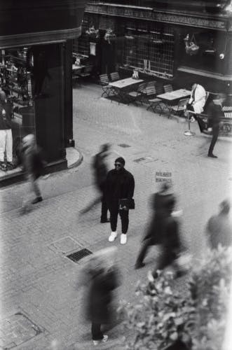 A man stands in the middle of a busy street