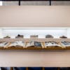 A line of shoes appear next to a line of books at Birkenstock's 250-year anniversary photo exhibition