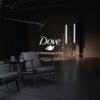 A darkened studio with two armchairs, and a Dove logo and the line 'A Greenpeace film' laid over the image