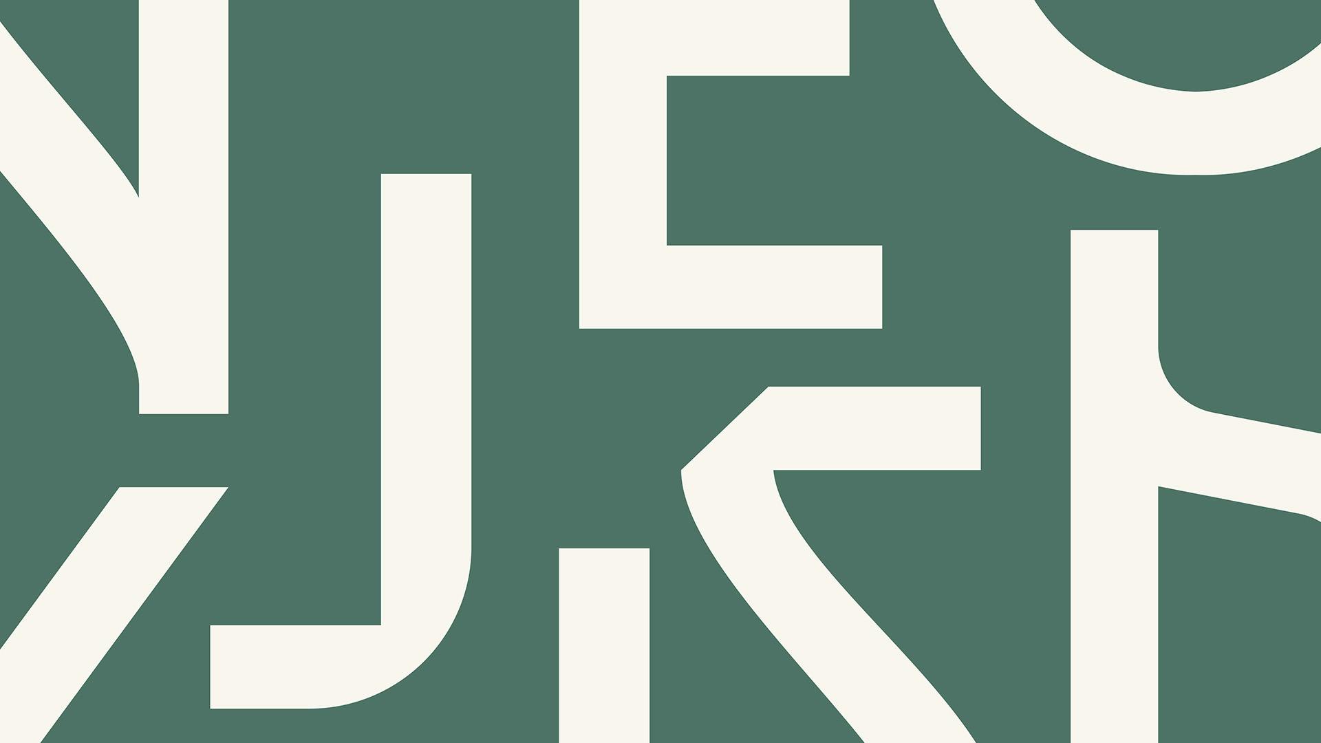 A muted green graphic with showing close-ups of white angular lettering