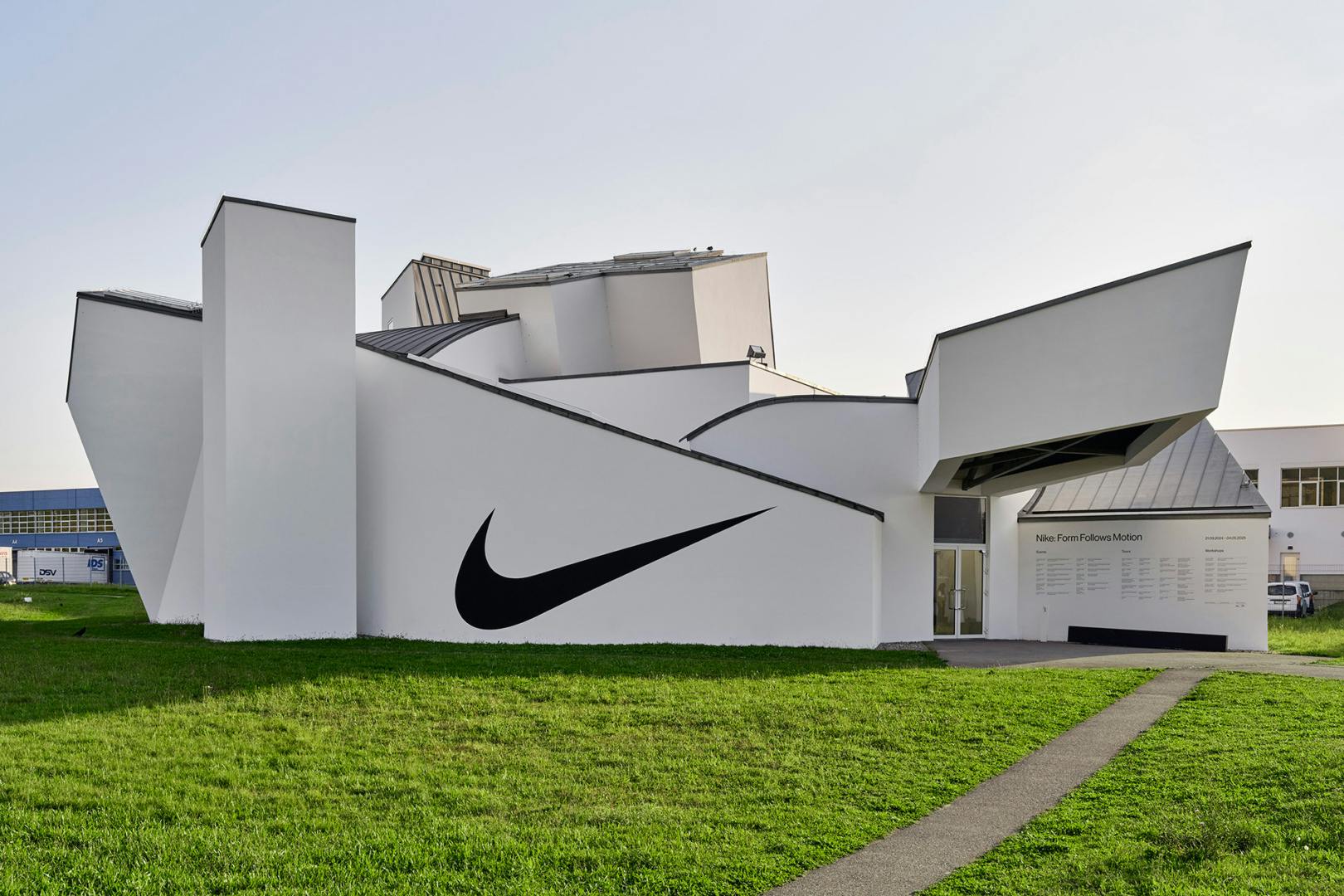 Angular exterior of Vitra Design Museum featuring the Nike Swoosh logo on the exterior