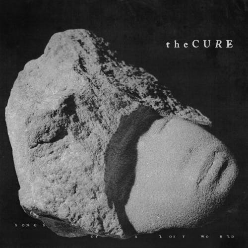 Cover the Cure's album Songs of a Lost World featuring a stone statue in the shape of a face