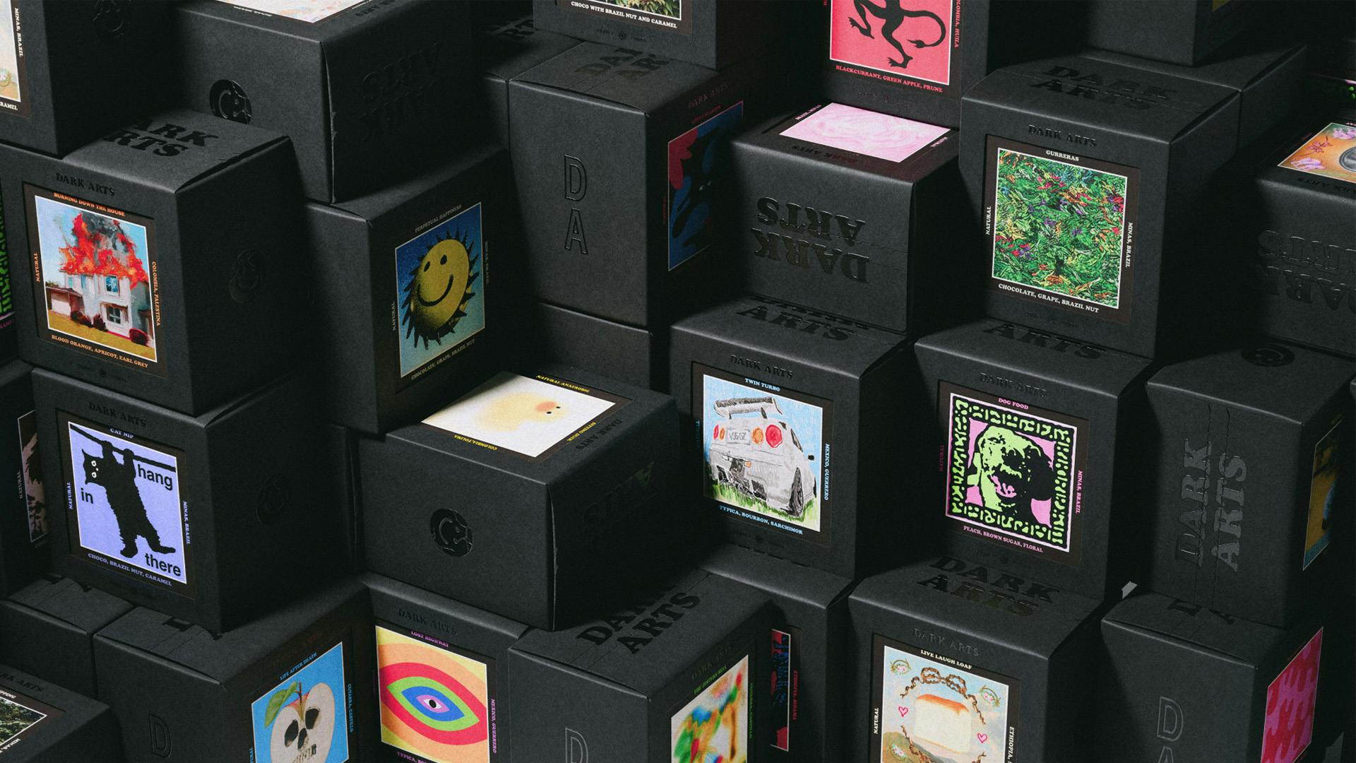 Stack of black boxes of Dark Arts coffee featuring illustrated cards on the front of each box