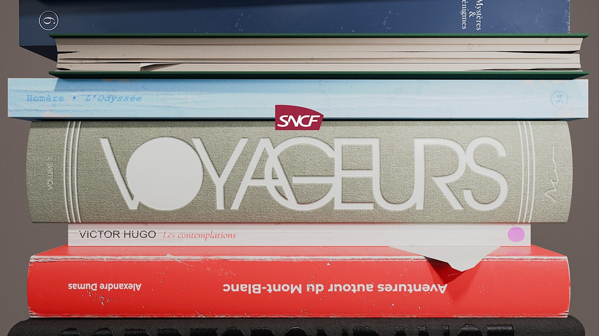 SNCF Voyageurs wordmark shown on the spine of a book in a stack of books